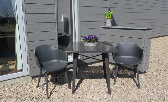 Patio seating ready for arrival drinks overlooking the valley view
